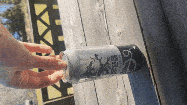 a person is opening a can that says fire citrus on it