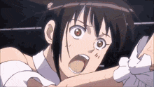 a close up of a person 's face with their mouth open and a very angry look on their face .