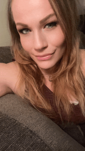 a close up of a woman 's face with a necklace around her neck