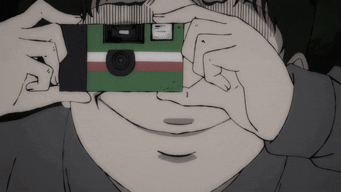a person is taking a picture with a green and red camera