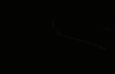 a close up of a person 's face in a dark room with a light shining through it .