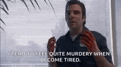 a man with blood on his hands is standing in front of a window with blinds and a quote .