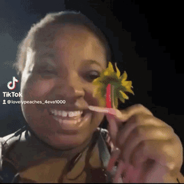 a woman is holding a flower in her mouth with a tik tok watermark