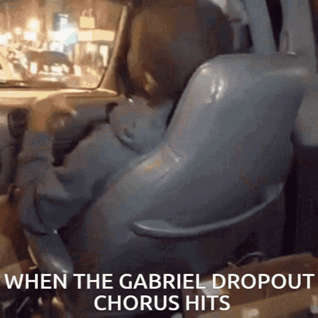 a person sitting in a car with the words " when the gabriel dropout chorus hits " on the bottom