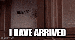 a brown door with the words i have arrived written on it