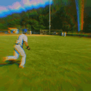 a baseball player in a white uniform is running towards a base