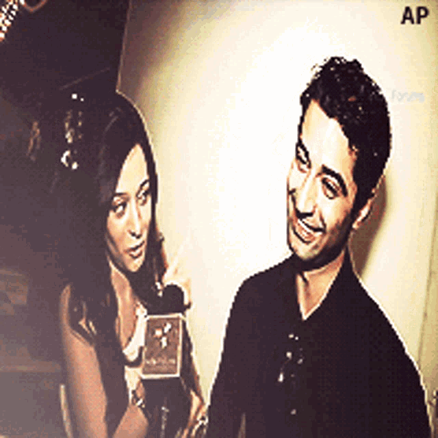 a man and a woman are standing next to each other and the word ap is on the bottom