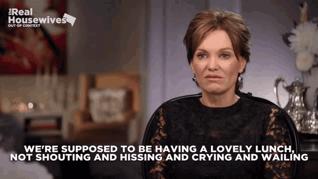 a woman is sitting in front of a sign that says ' real housewives out of context '