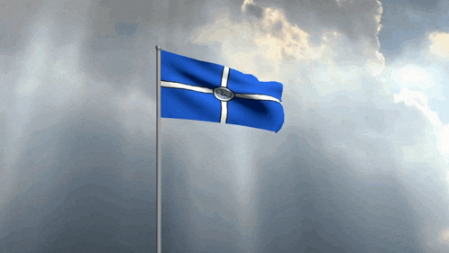 a blue and white flag with a cross on it is waving in the wind