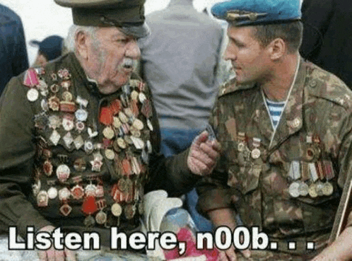 two men in military uniforms are sitting next to each other and one of them is wearing medals .