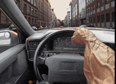 a volvo steering wheel is shown with a hand on the steering wheel