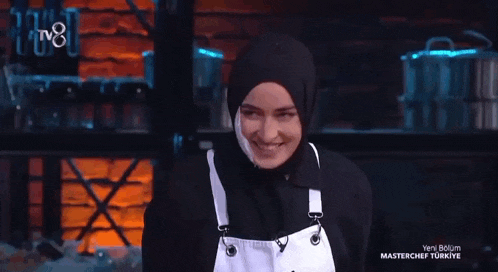 a woman wearing a hijab and an apron with the word beyza on it