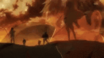 a group of people are standing on top of a hill in front of a large fire .