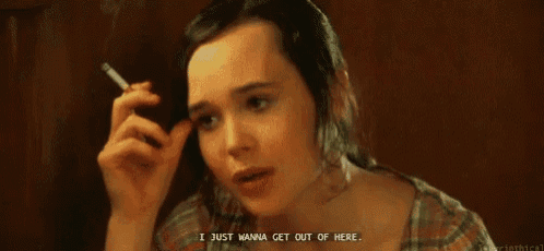 a woman is smoking a cigarette and says `` i just wanna get out of here . ''