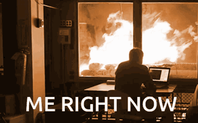 a man sits at a desk in front of a fire with the words me right now written above him
