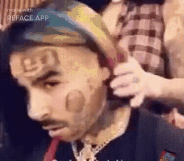 a man with a bandana on his head is getting his hair cut by a woman .