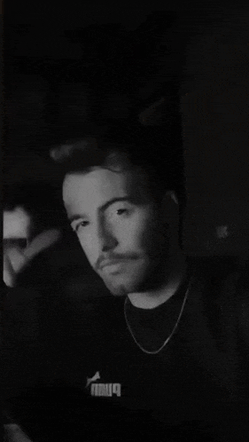 a black and white photo of a man 's face with a beard .