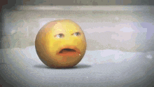 a yellow smiley face is sitting on a white surface with its mouth open .
