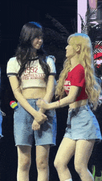 two girls are standing next to each other and one has a shirt that says 1992 on it