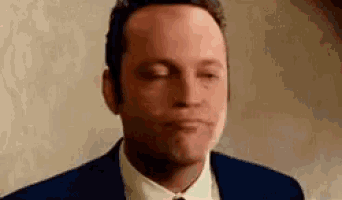 a man in a suit and tie with his eyes closed .