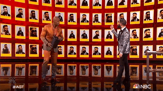 a man in a suit is standing in front of a wall of pictures of bearded men .