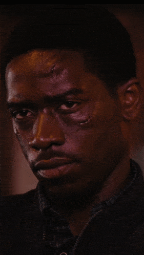 a close up of a man 's face with a few spots on it