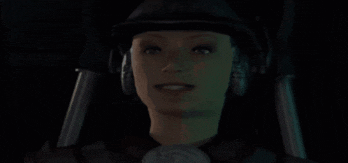 a woman wearing headphones and a hat is smiling in the dark