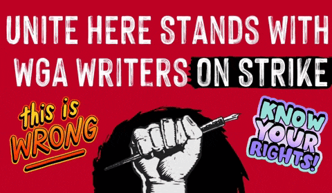 a red sign that says unite here stands with wga writers on strike