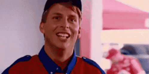 a man in a red and blue uniform is smiling .