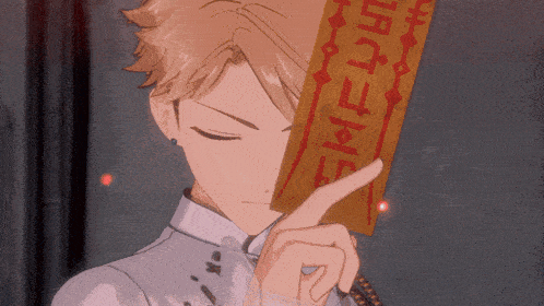 a person holding a piece of paper with chinese writing