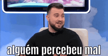 a man with a beard is sitting in front of a television with the words alguem percebeu mal written on the screen