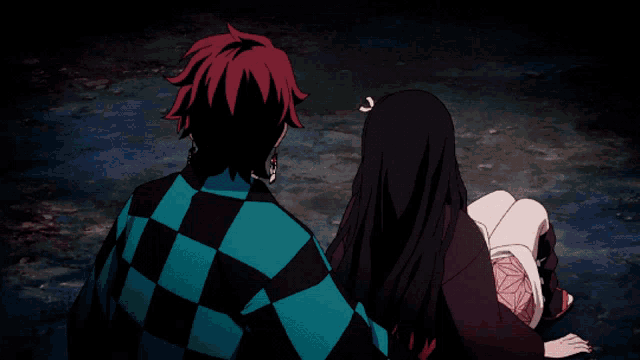 a man in a checkered shirt is holding a girl in a black and red outfit