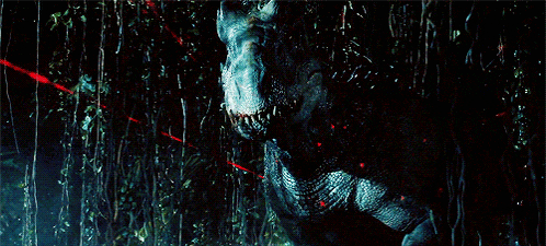 a t-rex is standing in a dark forest with red lights behind it