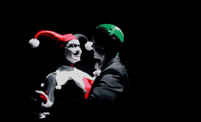 a man dressed as harley quinn with green hair and a red hat