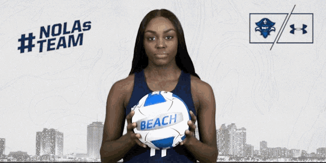 a woman holding a volleyball with the number 11 on her jersey