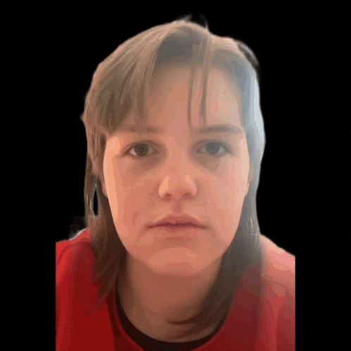 a woman in a red shirt looks at the camera