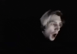 a close up of a person 's face in the dark .