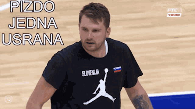 a man wearing a black t-shirt with slovenia on it