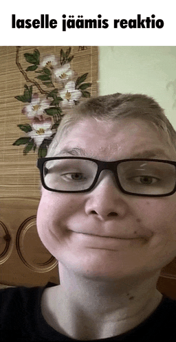 a man wearing glasses is making a funny face with the words laselle jaamis reaktio above him