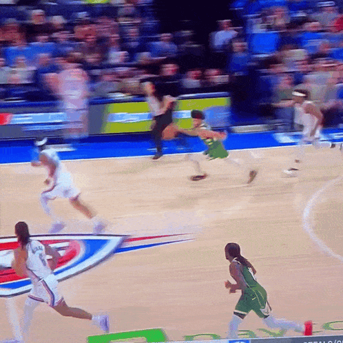 a basketball game is being played on a court with a sign that says ' nba '