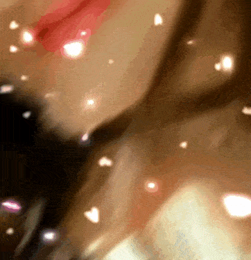 a blurry picture of a person 's face with hearts floating around