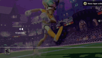a cartoon character is playing a video game called wario hyper strike ..