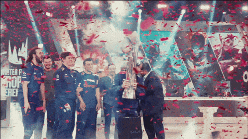 a man holding a trophy in front of a crowd with confetti falling