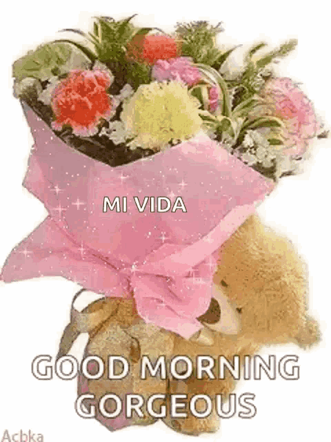a teddy bear is holding a bouquet of flowers and says good morning gorgeous .
