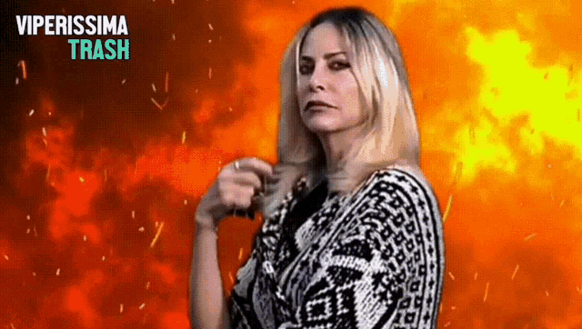 a woman is standing in front of an explosion and the words viperissima trash are visible