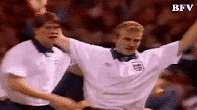 two soccer players are celebrating with their arms in the air and the letters bfv are on the bottom right