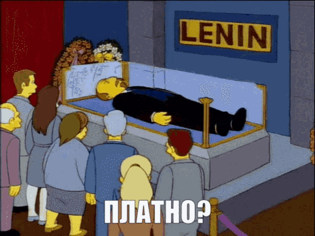 a group of people standing around a coffin with a sign that says lenin
