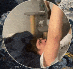 a man is laying on a bed with his arm up in the air