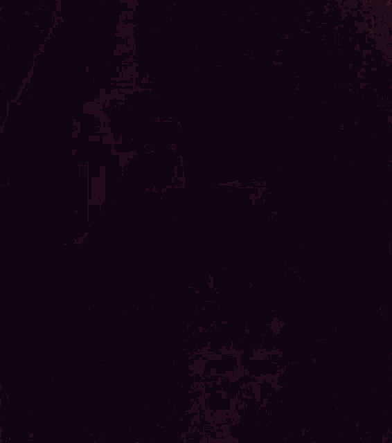 a blurry picture of a person 's face in a dark room with a purple background .