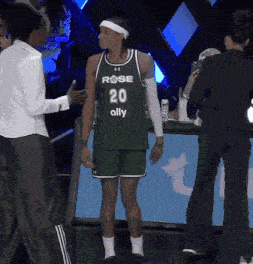 a basketball player wearing a green jersey with the number 20 ally on it